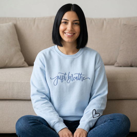 Just Breathe crewneck sweatshirt with inspirational graphic